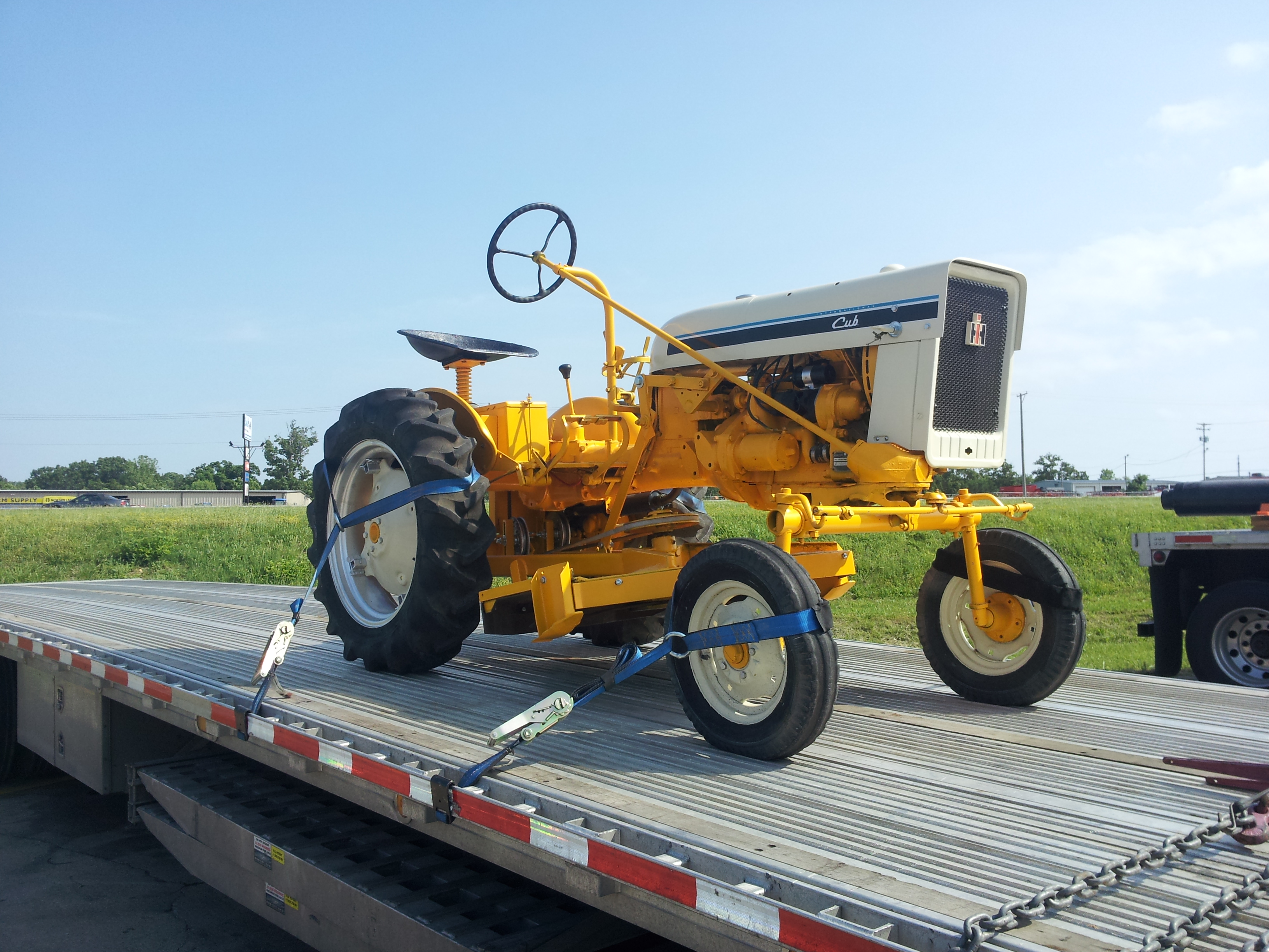 Cub tractor secured on a transport trailer